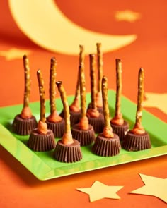 chocolate covered desserts on a green plate with stars and moon in the back ground