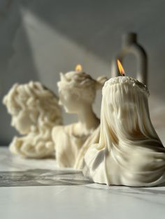 a candle that is sitting in the middle of some kind of sculpture on a table