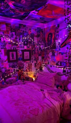 a bedroom with purple lights and pictures on the wall above the bed, along with other decorations