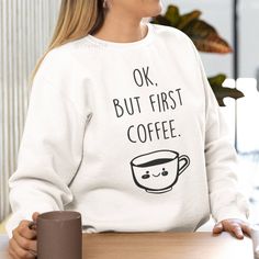 New! Ok, But First Coffee Graphic Sweatshirt. Sizing Is Unisex. Pullover Fleece Crewneck Sweatshirt With Long Sleeves. Ribbed Wrists & Waistband. Warm And Cozy Cotton/Polyester Blend. Style # Funny Cute Kawaii Drink Mug Sayings Spring Autumn Fall Winter Mens Womens Teens Casual Cute Large Graphic Custom Clothing Relaxed Baggy Comfy Loungewear Sleepwear Lounge Sweater Light Classic Solid Color New To Poshmark? Save $10 On Your First Purchase When You Sign Up For An Account With The Invite Code: F Cozy Sweatshirt With Text Print For Loungewear, Cozy White Sweatshirt With Graphic Print, Cozy Long Sleeve Graphic Sweatshirt, Coffee Crew Neck Sweatshirt For Winter, But First Coffee Sweatshirt, Mug Sayings, Ok But First Coffee, Lounge Sweater, Pullover Fleece