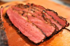 a piece of meat sitting on top of a wooden cutting board