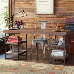 a room with a desk, chair and bookshelf in it next to a window