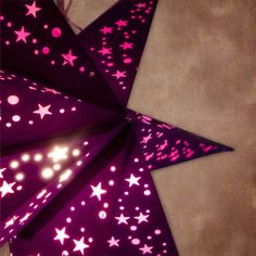 a purple paper star with pink and white stars on it