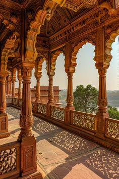 an ornate building with pillars and arches on the outside, looking out over water from inside