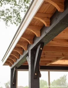 the underside of a wooden structure with metal brackets on it's sides and wood slats at the top