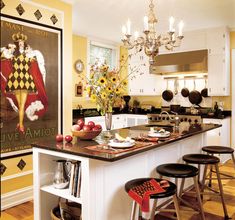 a kitchen island with stools in front of it and a poster on the wall