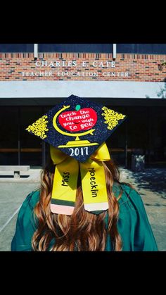 a woman wearing a graduation cap with an apple on it's top and the words,