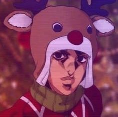 a person wearing a reindeer hat with horns on it's head in front of a blurry background