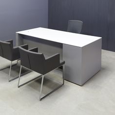 an office desk with two chairs next to it and a wall in the back ground