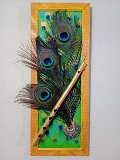 two peacock feathers on a green and yellow background with a flute in the foreground