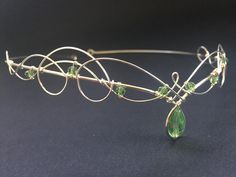 Wonderful celtic elven inspired headpiece, made to be worn over the forehead or on the hairline, this lovely unusual piece is a perfect alternative to a traditional tiara. The circlet is silver plated with a green crystal pear drop centre stone and small round green faceted crystals around the sides. All the stones used are Czech crystal in peridot green. Because the entire circlet is handmade it is both sturdy and also flexible and therefore very comfortable to wear however because of it's flex Fantasy Tiara, Crystals Crown, Wedding Circlet, Medieval Things, Elven Wedding, Green Crown