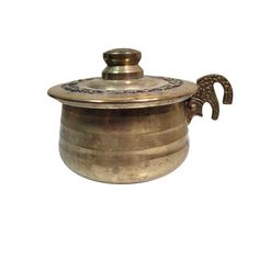 an old silver pot with a handle on the side and a decorative design on the lid