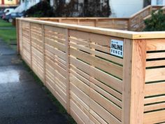 a wooden fence with a street sign on it that says inline science in front of a house