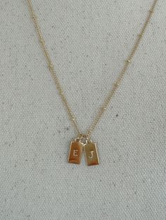 14k gold filled necklace | will not tarnish in water | satellite chain and dog tag are both gold filled | select from 16 in, 18 in, 20 in chain length | dog tag measures 13.5mm by 6mm | one initial per tag | initial is hand stamped and may differ slightly | please message us if more tags are needed Two Initial Necklace, Initial Necklace For Boyfriend, Couple Gifts For Both, Necklaces Letter, Gift Ideas For Moms, Initial Jewelry Necklace, Initial Tag Necklace, Children Names, Initials Necklace