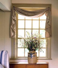 a vase filled with flowers sitting on top of a dresser