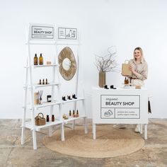 a woman standing behind a beauty shop counter