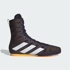 the adidas basketball shoe is shown in black and white, with gold trims