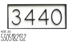 a white house number sign with black numbers