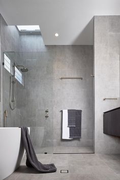 a modern bathroom with grey walls and flooring