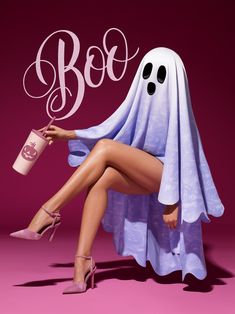 a woman sitting on top of a chair wearing a ghost costume and holding a cup