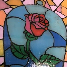 a stained glass window with a rose on it