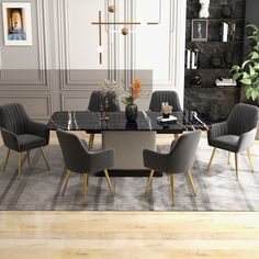 a dining room table with chairs and a rug on the floor in front of it