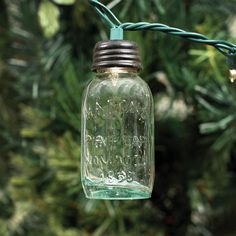 a mason jar hanging from a green wire with the number six on it's side