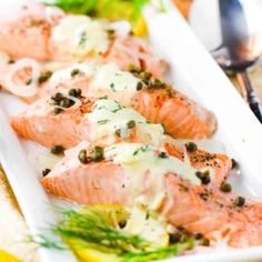 salmon with capers and lemons on a white plate