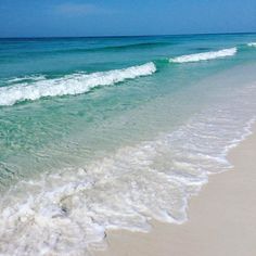 the ocean waves are rolling in to shore