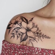 a woman's shoulder with flowers on it