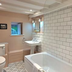 a bathroom with a tub, toilet and sink in it's center piece is shown