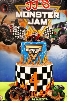 a monster jam birthday cake with cars on top and flames coming out of the front