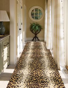 a leopard print rug on the floor in a hallway