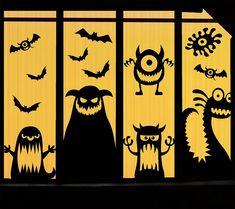 an image of halloween window decorations with bats and monsters in the window sill at night