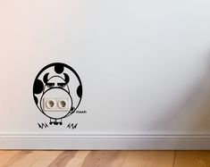 a wall with an animal sticker on it's side next to a wooden floor