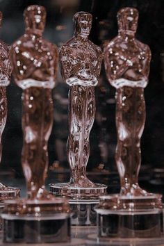 an assortment of glass figurines on display in a store window, with one standing out from the crowd