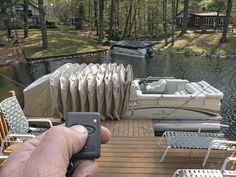 a person holding a remote control near a boat