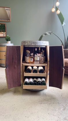 an open wine cabinet with several bottles in it