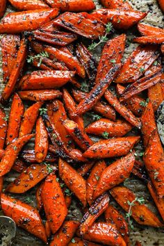 roasted carrots with herbs and salt on a baking sheet