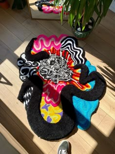 a person's feet are standing on the floor next to some colorful rugs