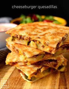 four quesadillas stacked on top of each other next to a bowl of salsa