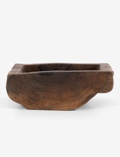 a wooden bowl sitting on top of a white surface