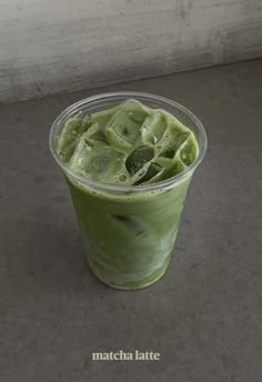 a green smoothie in a plastic cup