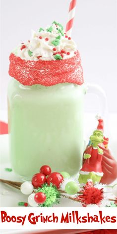 a green drink with whipped cream and sprinkles in it on a plate