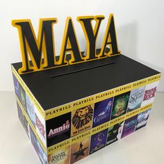 a black box with yellow letters that spell out the word mayoa on top of it