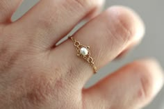 This chain with is so lovely. Easy to wear, Dainty and lightweight. Perfect for everyday wear. All jump rings are bonded closed making this ring more sturdy. Pearl measures 3mm. Rope chain measures 1mm. Handcrafted out of solid 14K gold. This ring runs small, it is recommended to order half a size larger than you normally wear. Want a different gemstone? Message Liesel Love- many are available. Processing times - Current processing time is 1 - 5 business days. Each Item is handmade to order with Gold Ring Chain, Pearl Rings, Small Pearl Ring, Gold Pearl Ring, Solid Gold Chains, Gold Gold, Jewelry Lookbook, Pearl Chain, Chain Ring