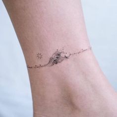 a woman's foot with a small tattoo on the left side of her ankle