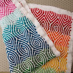 four pieces of crocheted fabric with different colors and patterns on them, one is multicolored