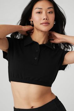 Give off the ultimate prep school chic vibes in the Cropped Prestige Polo. Its super-cropped, fitted silhouette will get you cool points at yoga class and with all your friends when you sport it for your next outing. Pair it with any high-waist bottom in your collection. Super-cropped, fitted silhouette Button-up with cool collar Designed & uniquely fit to flatter every size Wear-tested by our in-house team for the perfect fit Black Athleisure Cropped T-shirt For Workout, Trendy Fitted Cropped T-shirt For Workout, Sporty Black Crop Top For Summer, Trendy Black Crop Top For Loungewear, Trendy Black Crop Top For Workout, Alo Yoga Cropped Crop Top For Workout, Alo Yoga Cropped Top For Workout, Alo Yoga Crop Top For Workouts, Summer Cropped Athleisure Shirt