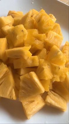 cut up pieces of pineapple on a white plate